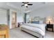 Light-filled primary bedroom featuring a tray ceiling and plush carpet at 11817 Phoebe St, Parker, CO 80134