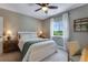Cozy bedroom with neutral tones, soft lighting, a ceiling fan, and a window with a lovely view at 11817 Phoebe St, Parker, CO 80134