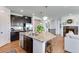 Open kitchen features granite counters, stainless steel appliances, and an island with seating at 11817 Phoebe St, Parker, CO 80134