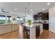 Open concept kitchen featuring a large island with seating, stainless steel appliances, and ample counter space at 11817 Phoebe St, Parker, CO 80134