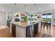 Spacious kitchen featuring granite countertops, stainless steel appliances, and a view of the living room fireplace at 11817 Phoebe St, Parker, CO 80134