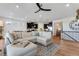 Spacious living room featuring hardwood floors, a comfortable sectional sofa, and an open layout into the kitchen at 11817 Phoebe St, Parker, CO 80134