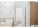 Bathroom featuring a single sink vanity and tiled shower, with an open doorway at 18846 E Yale Cir # A, Aurora, CO 80013