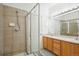 Bathroom featuring a glass-enclosed shower and double sink vanity at 18846 E Yale Cir # A, Aurora, CO 80013