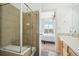 Bathroom with tiled shower and view of bedroom; showcasing modern amenities at 18846 E Yale Cir # A, Aurora, CO 80013