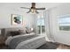 Bright bedroom featuring a ceiling fan, large windows with view, and stylish decor at 18846 E Yale Cir # A, Aurora, CO 80013