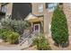 Inviting townhome entrance featuring a covered porch, stone accents, and manicured landscaping for added curb appeal at 18846 E Yale Cir # A, Aurora, CO 80013