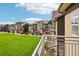 Modern townhome exterior showcasing balconies, manicured lawns, and community green space at 18846 E Yale Cir # A, Aurora, CO 80013