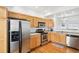 Efficient kitchen layout with stainless steel appliances, wood cabinetry, and ample counter space for meal preparation at 18846 E Yale Cir # A, Aurora, CO 80013