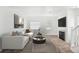 Bright living room featuring neutral walls, a cozy fireplace, and ample natural light, creating a welcoming atmosphere at 18846 E Yale Cir # A, Aurora, CO 80013