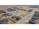 Aerial view of a community with homes, a park, and surrounding roads at 17847 E 95Th Ave, Commerce City, CO 80022