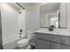 Bathroom featuring gray vanity, a tiled shower and tub combination at 17847 E 95Th Ave, Commerce City, CO 80022