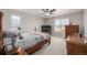 Bedroom features a ceiling fan, large bed, and window at 17847 E 95Th Ave, Commerce City, CO 80022
