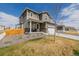 A welcoming two-story home with a covered front porch and attached garage at 17847 E 95Th Ave, Commerce City, CO 80022