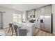 Modern kitchen with a breakfast bar, stainless steel appliances, and bright lighting at 17847 E 95Th Ave, Commerce City, CO 80022