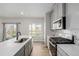 Stylish kitchen featuring light gray cabinets, a breakfast bar, and stainless steel appliances at 17847 E 95Th Ave, Commerce City, CO 80022