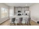 Contemporary kitchen with stainless steel appliances, an island, quartz countertops, and gray cabinets at 17847 E 95Th Ave, Commerce City, CO 80022