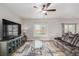 Bright living room boasting a comfortable couch, large window, modern TV and beautiful flooring at 17847 E 95Th Ave, Commerce City, CO 80022