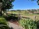 Scenic backyard view featuring a fence, lush greenery, and residential neighborhood beyond at 6031 S Irvington Ct, Aurora, CO 80016