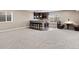 Finished basement featuring a wet bar with seating, carpet, and a seating area at 6031 S Irvington Ct, Aurora, CO 80016
