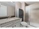 The bathroom features a shower and a sink with white cabinets and dark accents at 6031 S Irvington Ct, Aurora, CO 80016