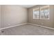 Bedroom featuring neutral walls, carpet, and natural light from a double window at 6031 S Irvington Ct, Aurora, CO 80016