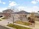 Aerial view of a tan home with stone accents and a two-car garage at 6031 S Irvington Ct, Aurora, CO 80016