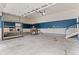The garage features shelving with painted stripes on the walls at 6031 S Irvington Ct, Aurora, CO 80016