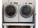 Laundry room featuring updated front load washer and dryer on a platform at 6031 S Irvington Ct, Aurora, CO 80016