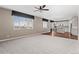 Open floor plan with carpeted living room and a view of the kitchen at 6031 S Irvington Ct, Aurora, CO 80016