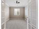 Home office or study with neutral paint, carpeted floors, and French doors at 6031 S Irvington Ct, Aurora, CO 80016