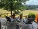 Comfortable patio area with outdoor seating, potted plants, and views of the landscaped backyard at 6031 S Irvington Ct, Aurora, CO 80016
