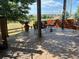 Covered patio showcasing stamped concrete flooring, outdoor seating, and a serene backyard view at 6031 S Irvington Ct, Aurora, CO 80016