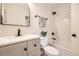 Bright bathroom with subway tile shower over tub and updated vanity at 709 S Alkire St, Lakewood, CO 80228