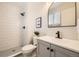 Modern bathroom featuring a walk-in shower with white subway tile and black hardware at 709 S Alkire St, Lakewood, CO 80228