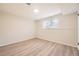 Bright bedroom with a window, light-colored walls, and wood-look flooring, ready for personalized decor at 709 S Alkire St, Lakewood, CO 80228