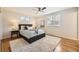 Bright bedroom featuring hardwood floors, neutral walls, ceiling fan and soft, cozy rug at 709 S Alkire St, Lakewood, CO 80228