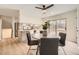 Bright dining area adjacent to the kitchen, featuring a modern ceiling fan and sliding glass door to backyard at 709 S Alkire St, Lakewood, CO 80228