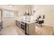 Bright kitchen features stainless steel appliances, a modern island and adjacent dining area at 709 S Alkire St, Lakewood, CO 80228