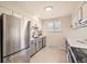 Modern kitchen featuring stainless steel appliances, and white and gray cabinets with dark hardware at 709 S Alkire St, Lakewood, CO 80228