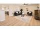 Bright living room with hardwood floors, a modern ceiling fan, and an open concept to the kitchen at 709 S Alkire St, Lakewood, CO 80228