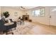 Inviting living room featuring a brick fireplace, large windows, and modern furniture on light wood floors at 709 S Alkire St, Lakewood, CO 80228