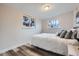 Comfortable bedroom with hardwood floors, a large window, and soft bedding at 3656 Fairfax St, Denver, CO 80207
