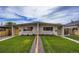 Inviting exterior of a modern duplex with well-manicured lawn and freshly painted doors at 3656 Fairfax St, Denver, CO 80207