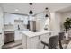 Modern kitchen with stainless steel appliances, quartz countertops, and a center island with pendant lighting at 3656 Fairfax St, Denver, CO 80207