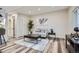 Cozy living room with neutral tones, modern decor, stylish furnishings, and wood-like flooring at 3656 Fairfax St, Denver, CO 80207