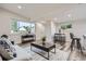 Bright living room with large windows, modern furnishings, and neutral colors offers an open space at 3656 Fairfax St, Denver, CO 80207