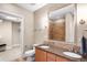 Bathroom featuring a double sink vanity and a tiled shower at 7600 Landmark Way # 904, Greenwood Village, CO 80111