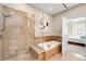 Bathroom features a modern glass shower, a soaking tub, and elegant tile work at 7600 Landmark Way # 904, Greenwood Village, CO 80111