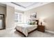 Calm bedroom featuring neutral colors, a large window, and two decorative lamps on wood nightstands at 7600 Landmark Way # 904, Greenwood Village, CO 80111
